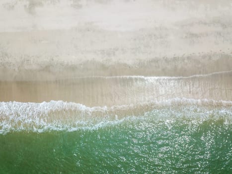 Blue ocean wave on clean sandy beach. Holidays and Travel Concept