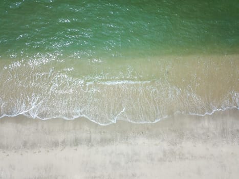 Blue ocean wave on clean sandy beach. Holidays and Travel Concept