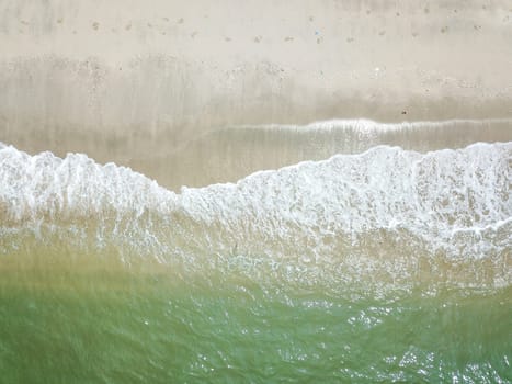 Blue ocean wave on clean sandy beach. Holidays and Travel Concept