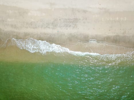 Blue ocean wave on clean sandy beach. Holidays and Travel Concept
