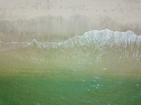 Blue ocean wave on clean sandy beach. Holidays and Travel Concept