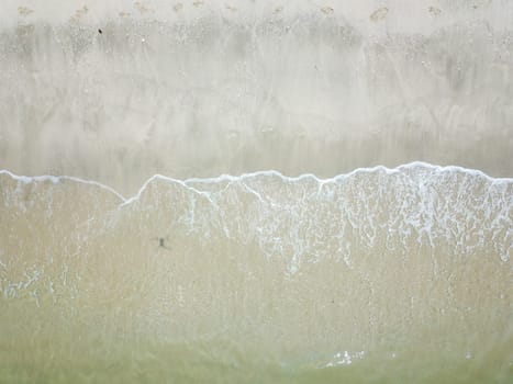Blue ocean wave on clean sandy beach. Holidays and Travel Concept