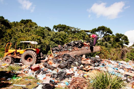 porto seguro, bahia / brazil - july 6, 2010: people are seen discarding garbage in a dump near Praia do Espelho in the municipality of Porto Seguro.