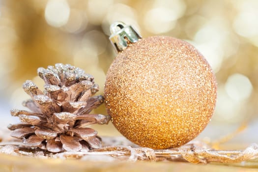 Golden Christmas background with christmas ball and cone