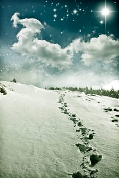 Christmas background with snowy path on the hillside