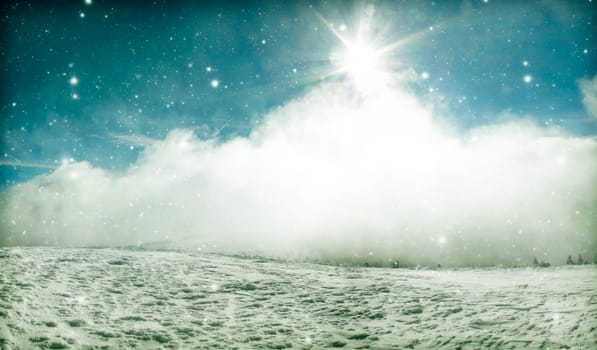 Winter landscape with snow covered hill and cloudy blue sky