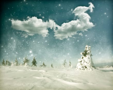Winter landscape with snow covered hill and cloudy blue sky