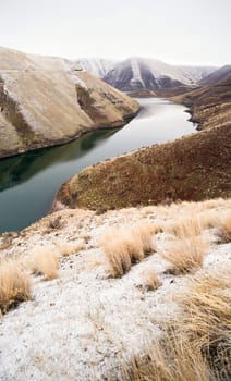 The road overlooks a weathered and historic landscape in the winter Oregon Landscape