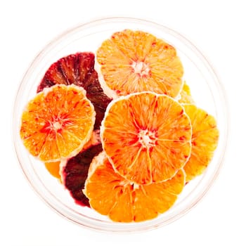 Orange and blood orange slices in glass bowl isolated on white