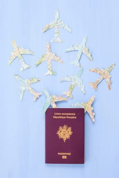 French passport with planes on blue background