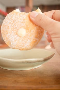 Cream donut on vintage background, stock photo