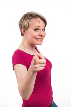 Portrait of a nice woman pointing someone in front of her, isolated on white