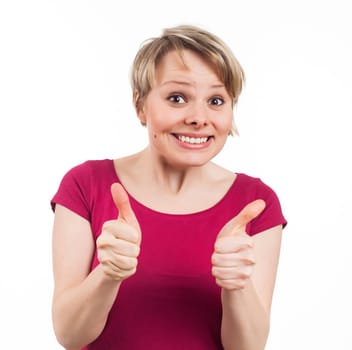 Young woman showing her thumbs up and having a pretty smile, isolated on white