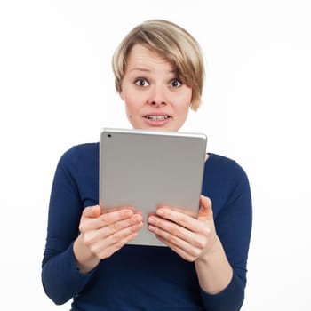 Young woman holding an electronic tablet and looking disturbed, isolated on white