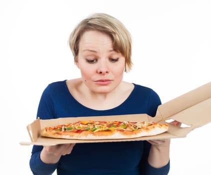 Young woman looking at a pizza from fast food and looking very attracted, isolated on white