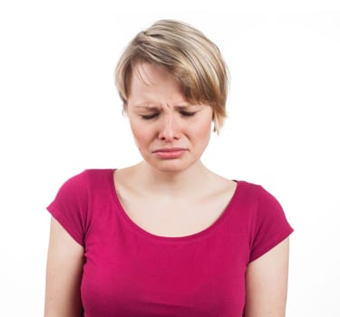 Young woman looking sad and about to cry, isolated on white