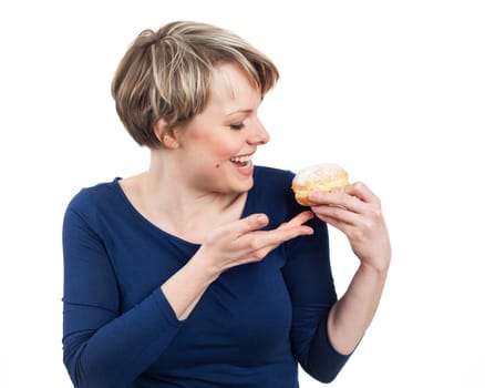 Young woman excited about eating a donut, isolated on white