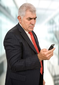 mature businessman on the phone at the office