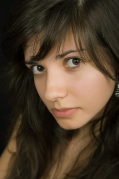 young beautiful brunette portrait against black background