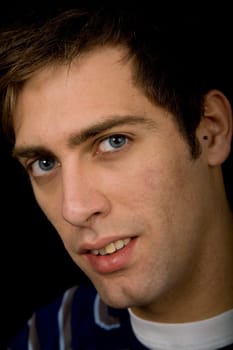 young casual man against a black background