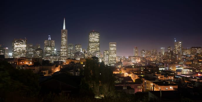 Night falls over the recognizable downtown skyline of San Francisco