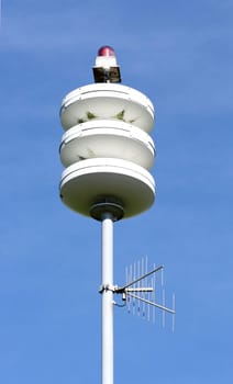 A street lamp, blue sky in the background.