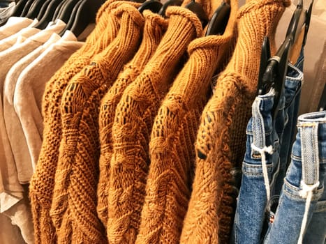 Different types of winter sweaters for sale at a nearby store