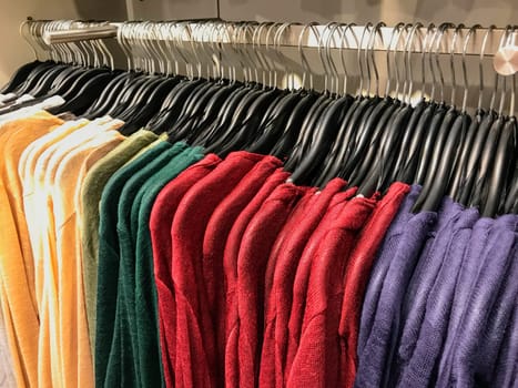 Different types of winter sweaters for sale at a nearby store