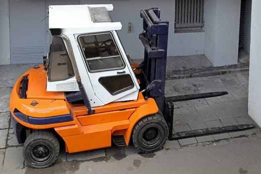 Industrial forklift commercial land vehicle in warehouse.
