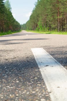 Empty road with forest landscape, concept of target or voyage, Belarus, vertical image