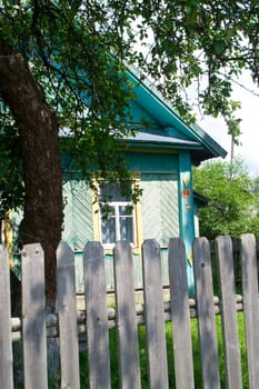 Authentic colourfully painted old wooden house in Belarus, vertical image