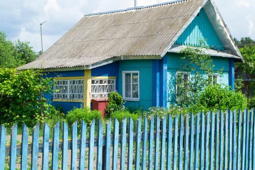 A traditional folk wooden rural house in Belarus with colorful ornamented