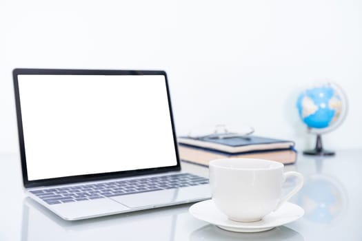 Laptop mockup with blank screen and book and simulated world on table