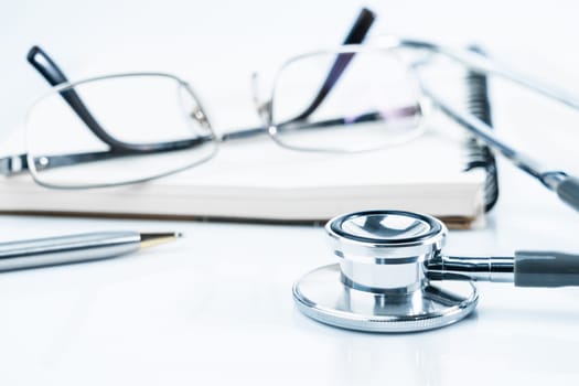 Close up Medical stethoscope with blank notepad as medical concept
