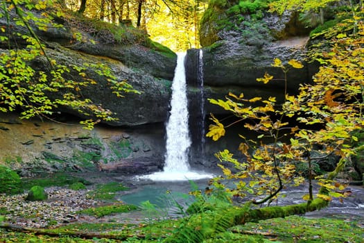 Waterfall in the wild in autumn