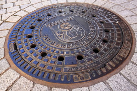 Tauberbischofsheim, Baden-Württemberg / Germany - 13 05 2019: Manhole cover of Tauberbischofsheim with coat of arms