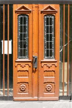 a front door with stained glass and wooden ornaments.
