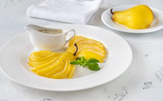 Portion of Saffron Poached  Pears on white plate