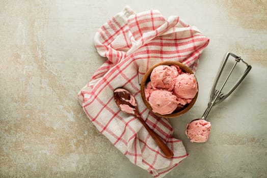Fresh of soft ice cream or frozen yogurt with berry fruit flavours. Fruit ice cream scoop, scooped with a utensil