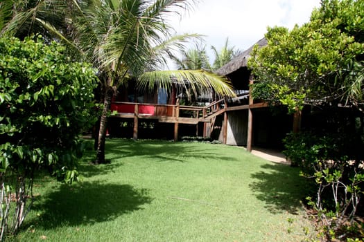 porto seguro, bahia / brazil - jeneiro 15, 2008: beach house with a piacava fiber roof is seen in the Trancoso district in the city of Porto Seguro.