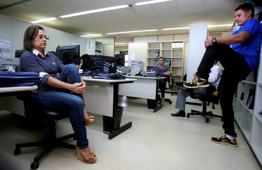 salvador, bahia / brazil - december 17, 2014: employees of the regional labor court in the city of Salvador are seen doing work gymnastics in the workplace.