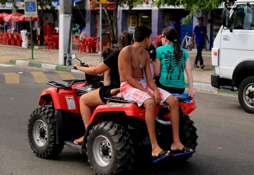 camacari, bahia / brazil - january 22, 2015: young man is seen without protective equipment, flying a quad in the Guarajuba district in the city of Camacari.