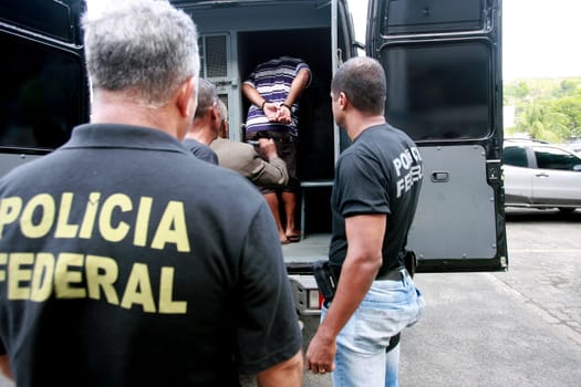 salvador, bahia / brazil - november 13, 2014: Federal police officers escort prisoners during a police operation in the city of Salvador.