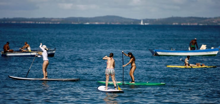 salvador, bahia / brazil - october 25, 2014: people are seen practicing Stand Up on Porto da Barra beach in the city of Salvador.