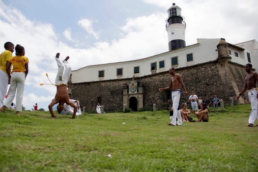 salvador, bahia / brazil - november 23, 2014: Capoeiristas are seen practicing art at Farol da Barra in the city of Salvador.