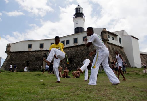 salvador, bahia / brazil - november 23, 2014: Capoeiristas are seen practicing art at Farol da Barra in the city of Salvador.