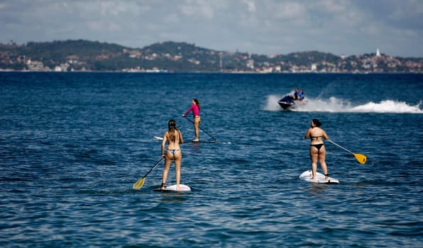 salvador, bahia / brazil - october 25, 2014: people are seen practicing Stand Up on Porto da Barra beach in the city of Salvador.