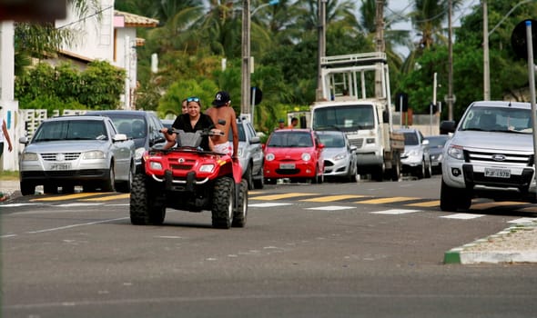 camacari, bahia / brazil - january 22, 2015: young man is seen without protective equipment, flying a quad in the Guarajuba district in the city of Camacari.