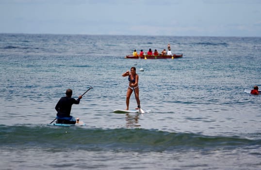 salvador, bahia / brazil - october 25, 2014: people are seen practicing Stand Up on Porto da Barra beach in the city of Salvador.