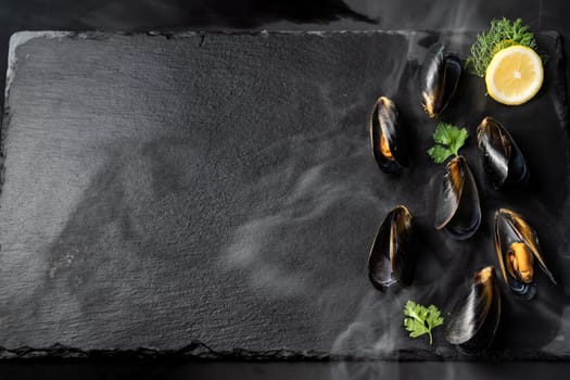 Fresh oyster serve with lemon in basket on black stone plate. Fresh seafood food and european cuisine gourmet concept.